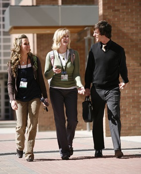 Three people walking and talking on CU Anschutz Medical Campus; sunny day