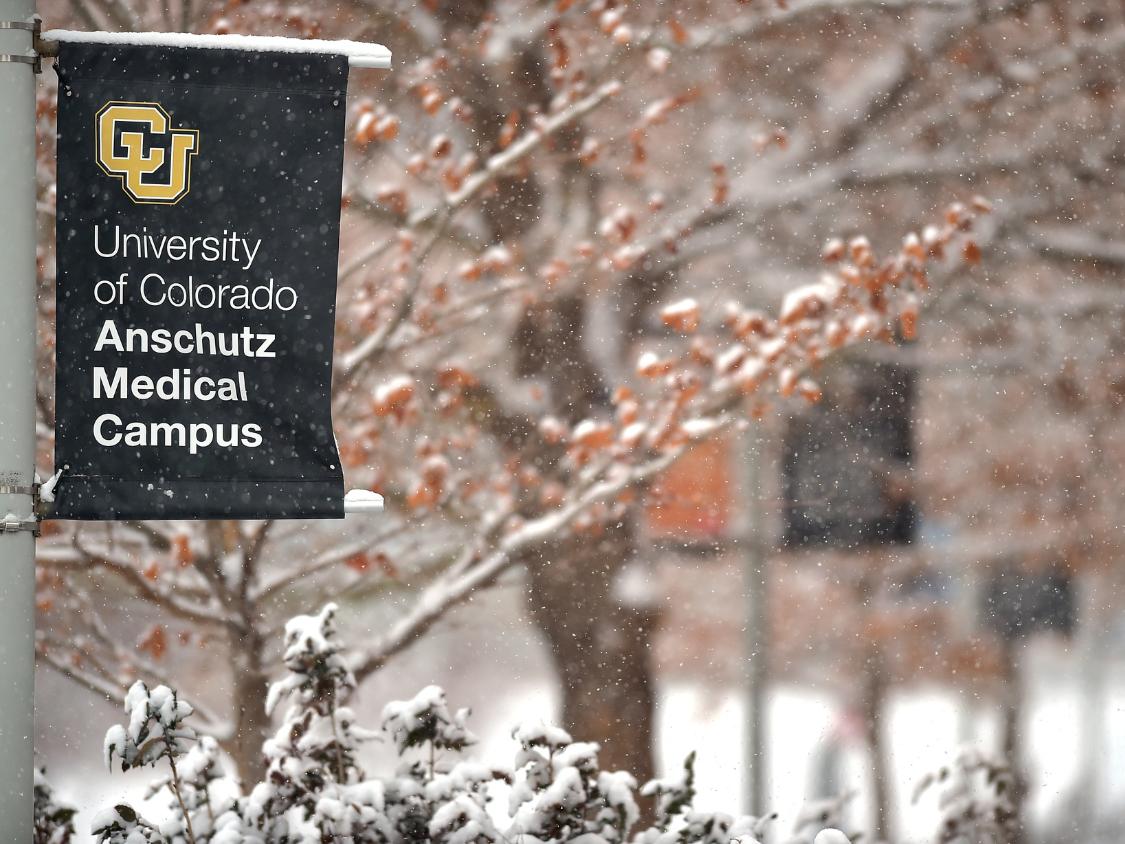 A snowy CU Anschutz campus sign.
