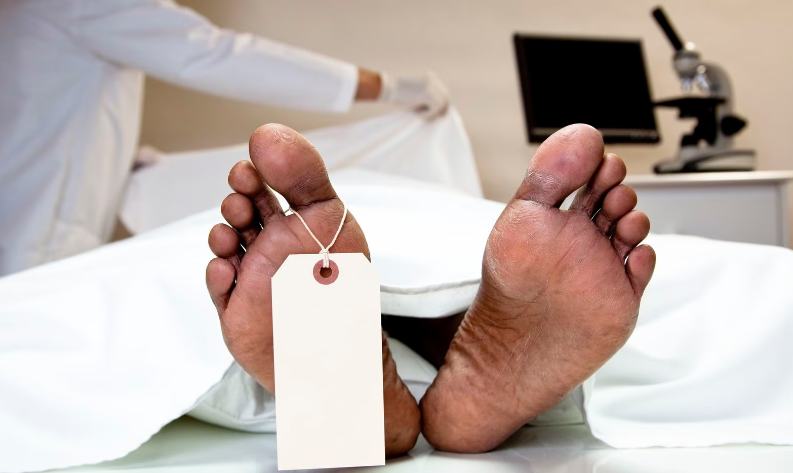 Photo illustration of a toe tag on a cadaver
