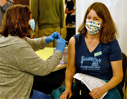 School nurse at Cottonwood Creek Elementary in the Cherry Creek district receives a vaccine
