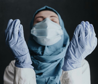 A Muslim healthcare provider wearing PPE