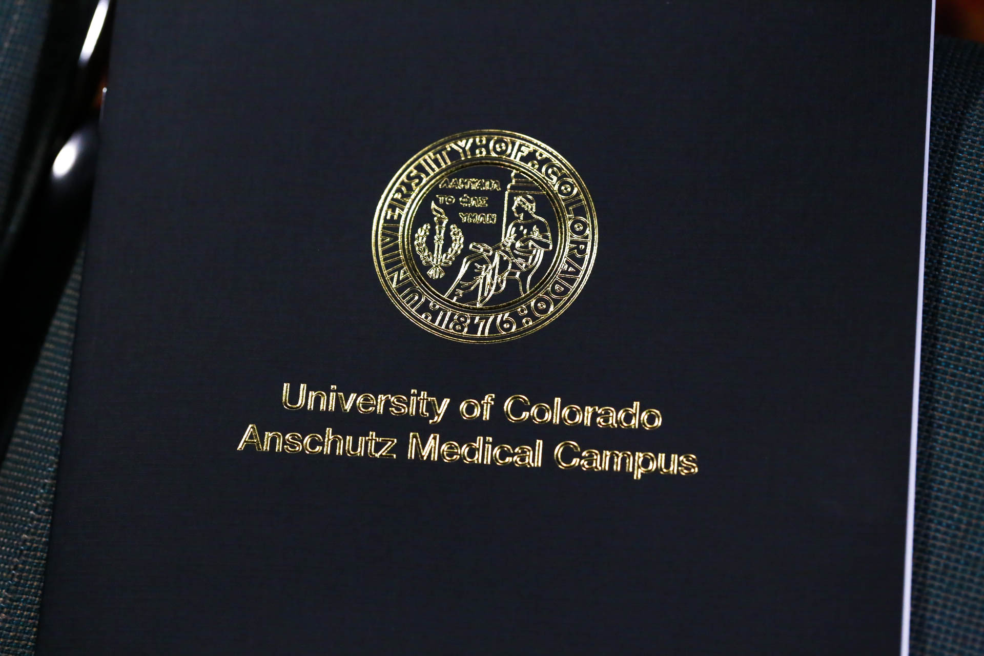 Close up photo of cover of commencement program with university seal embossed