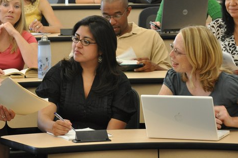 CU Anschutz students in a classroom looking at papers 