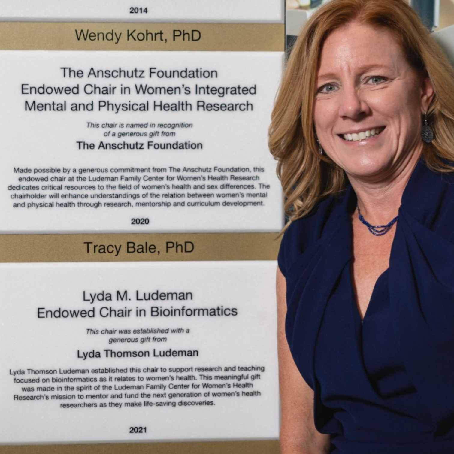 Tracey Bale, PhD, poses next to her Endowed Chair plaque on the wall of the Anschutz Health Sciences building.