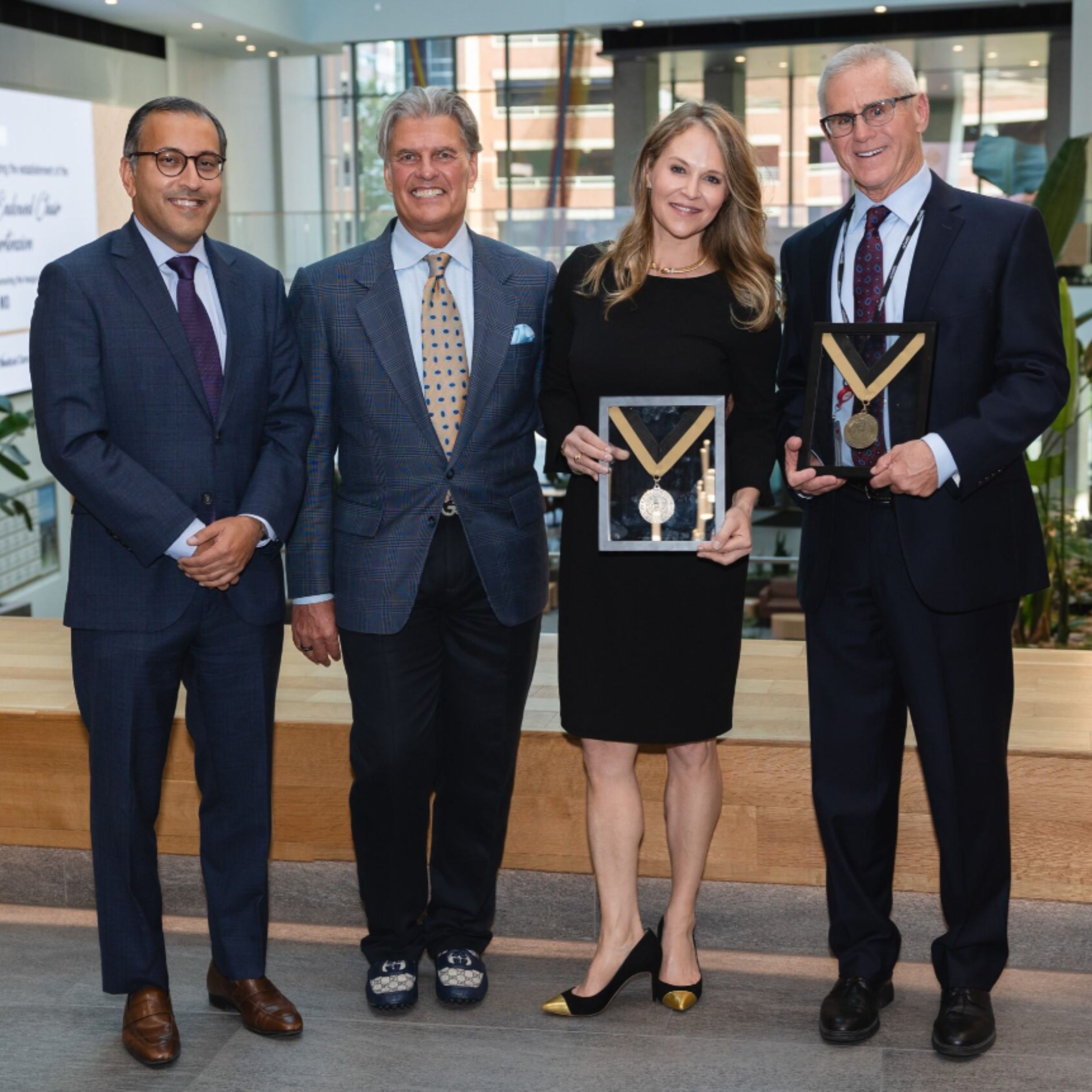 Kerry and Megan Hicks pose for a photo with Dr. Vineet Chopra and Dr. David Badesch. Megan and Dr. Badesch hold endowed chair medals.