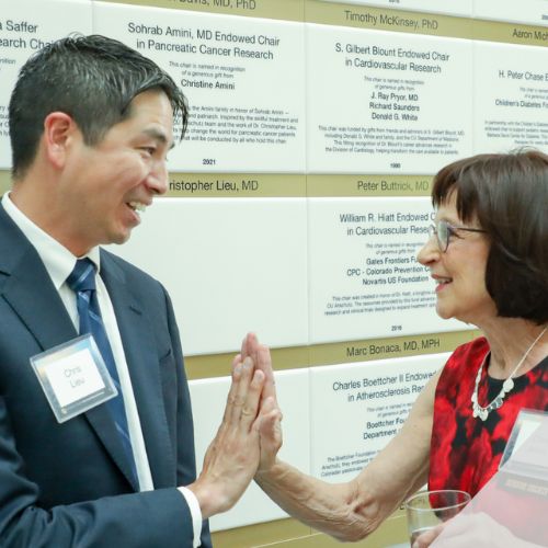 Chris Lieu, MD, the CU Cancer Center's associate director of clinical research, celebrates with benefactor Chris Amini.