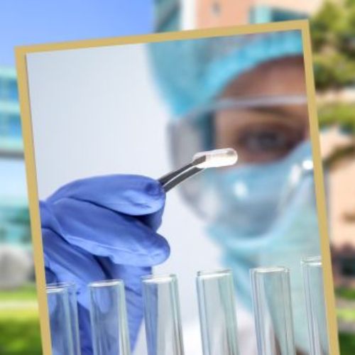 SOC Article Thumbnail - GA - Garcia-Adamson A researcher wearing full protective gear holds a pill using tweezers above a row of test tubes.