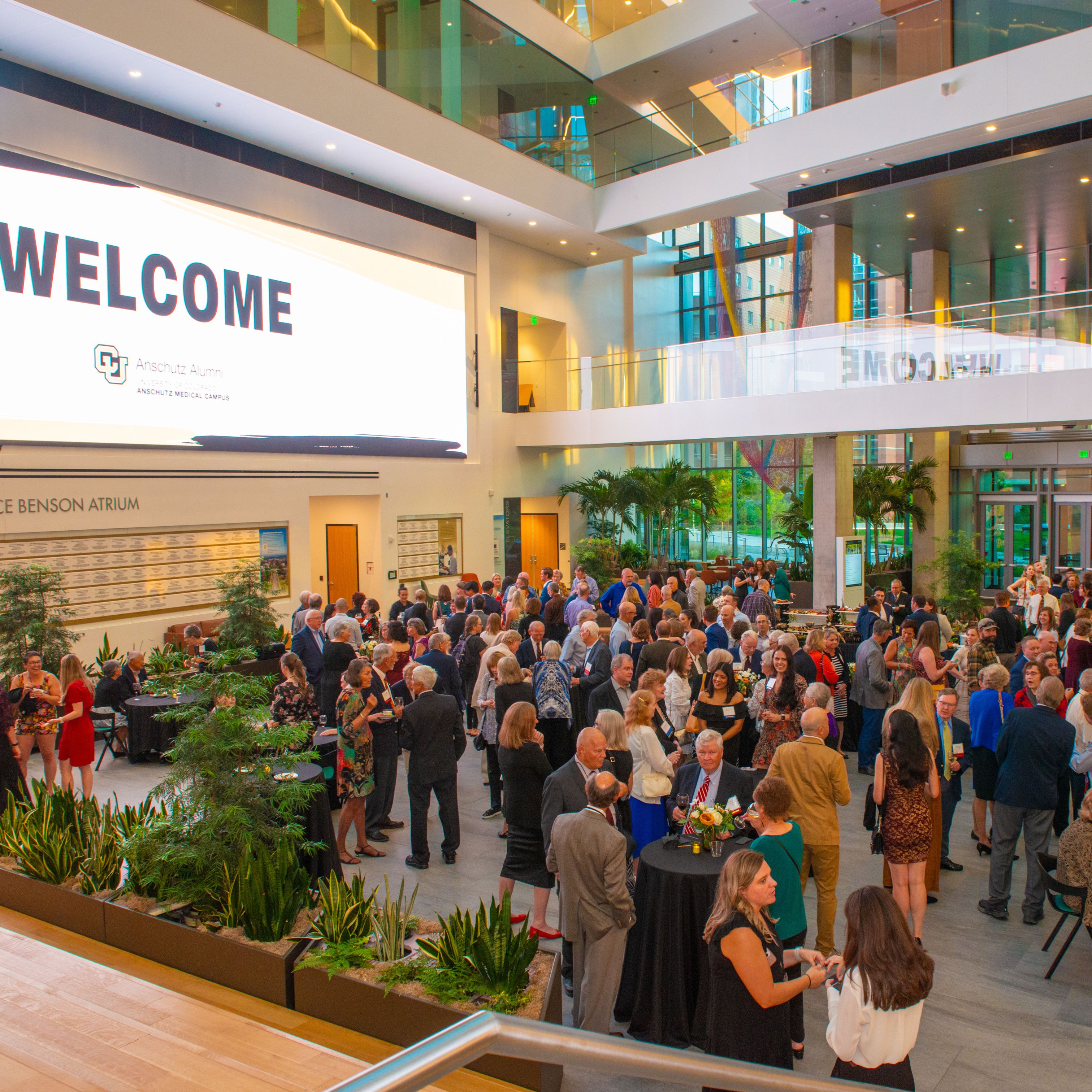 Health Sciences Building atrium filled with guests of the Alumni Reunion Celebration Dinner enjoying cocktails before the official reception.