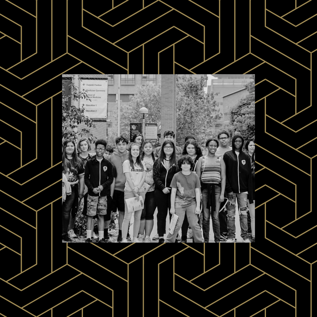 Black and white image of a group of middle school students on the CU Anschutz campus over a black and gold geometric background.