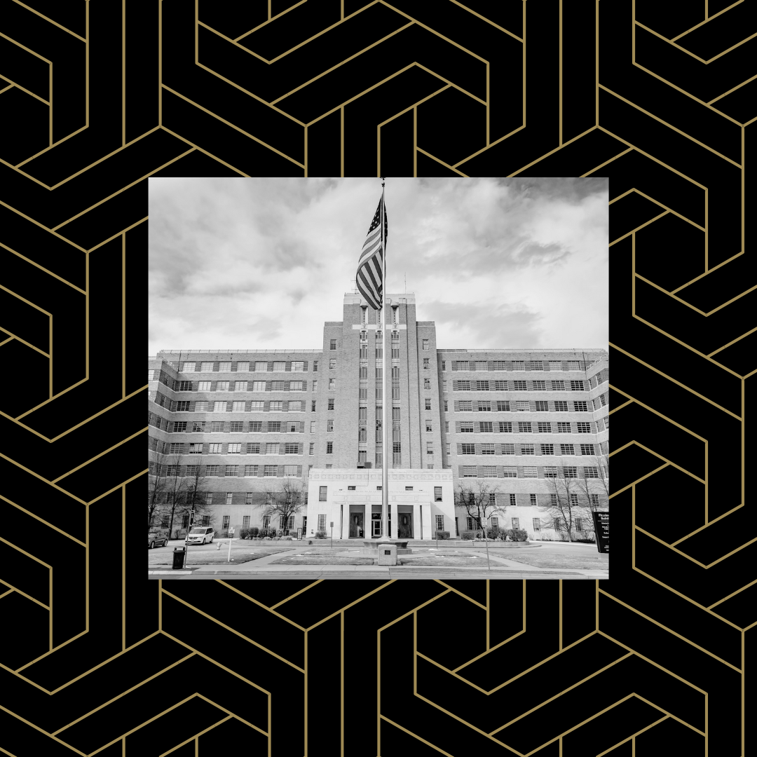 Black and white image of the Fitzsimons Building at CU Anschutz over a black and gold geometric background.