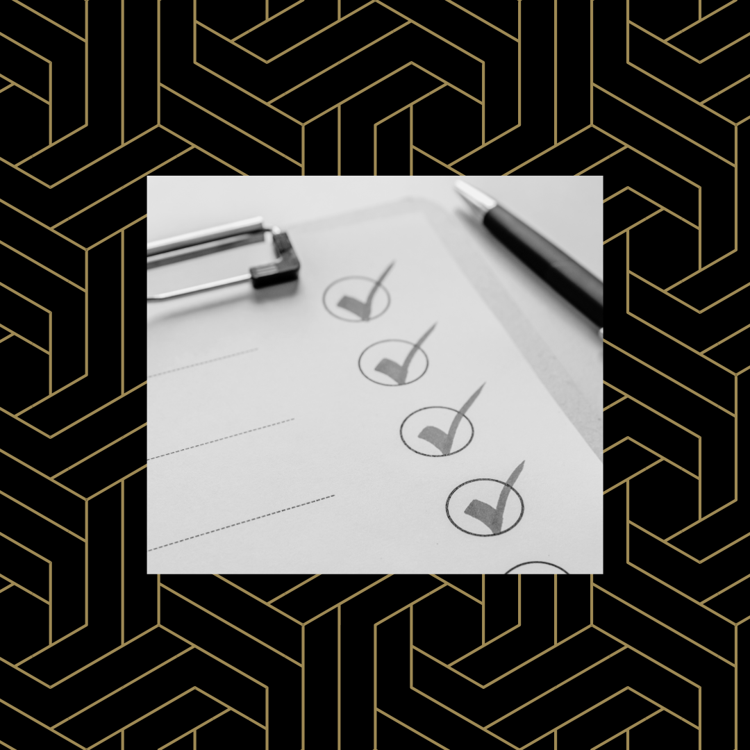Black and white image of a clipboard with a checklist on it over a black and gold geometric background.
