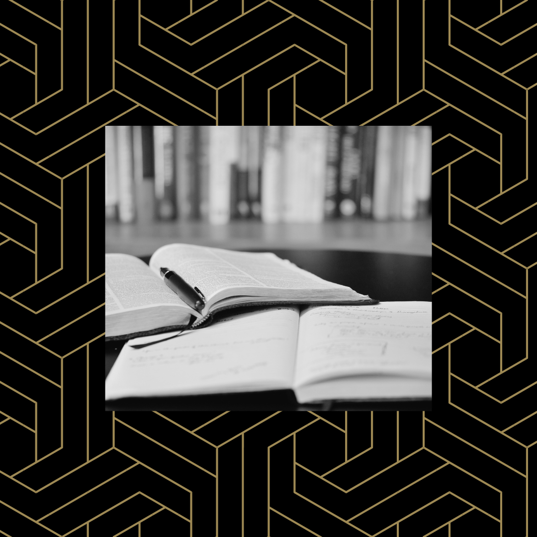 Black and white image of open books stacked on each other over a black and gold geometric pattern