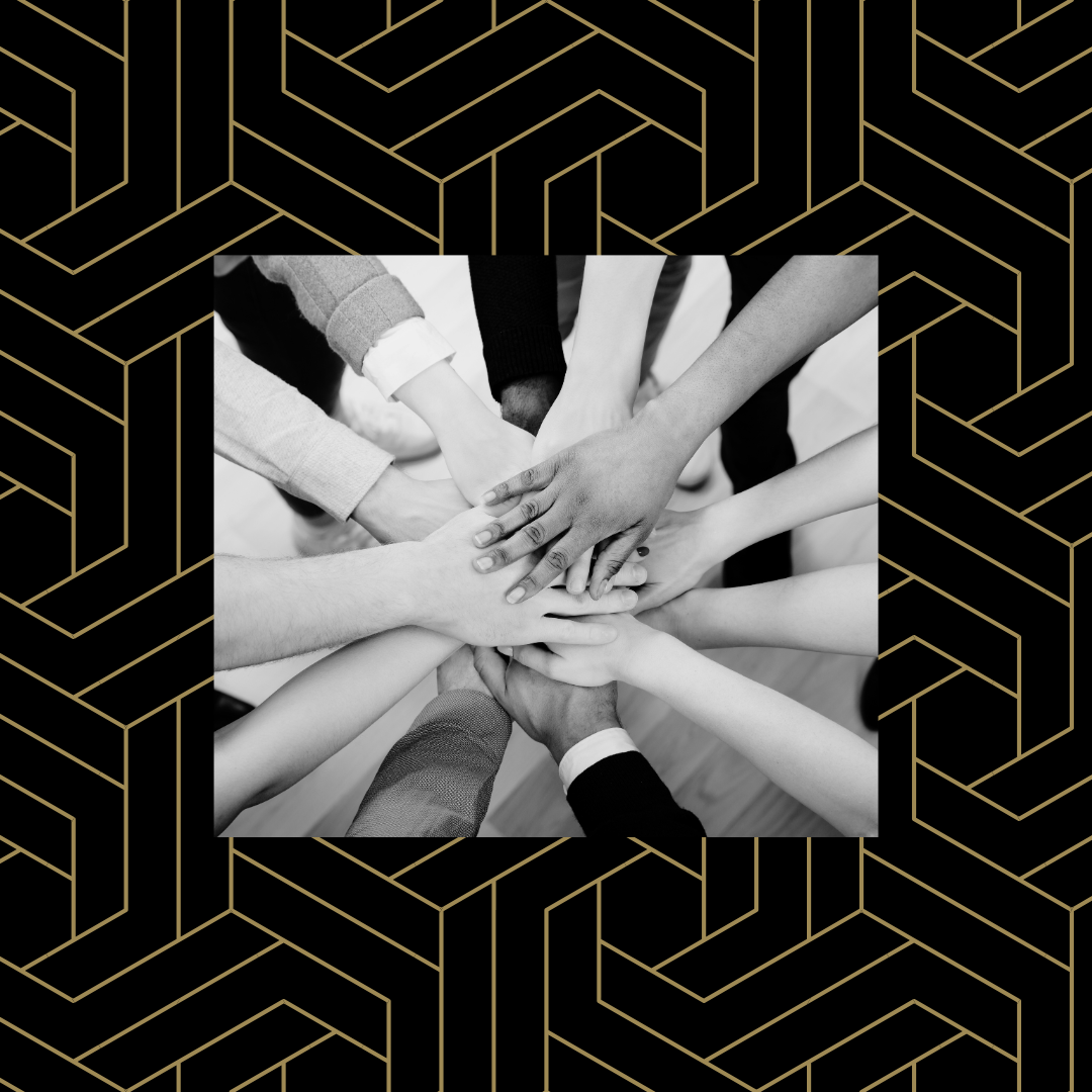 Black and white image of hands stacked on top of each other over a black and gold geometric background.