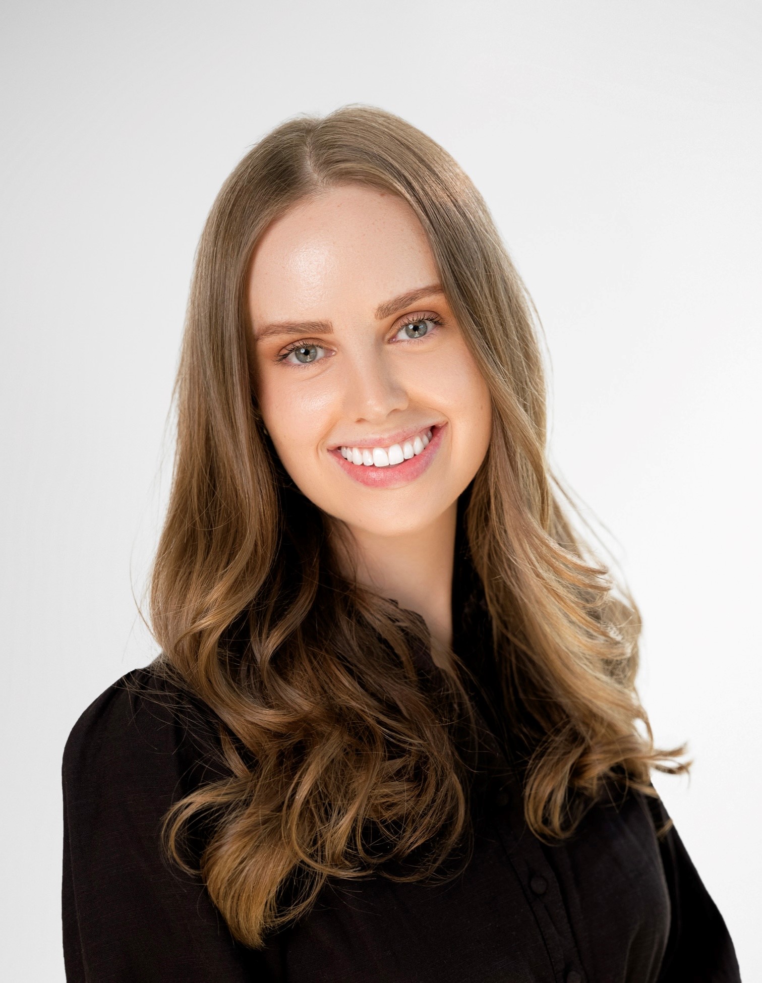 a picture of a woman with long blondish-brown hair wearing a black shirt
