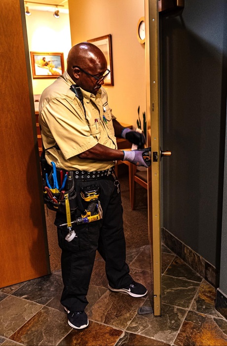 Security Engineer Gary Anderson working on electronic security of door