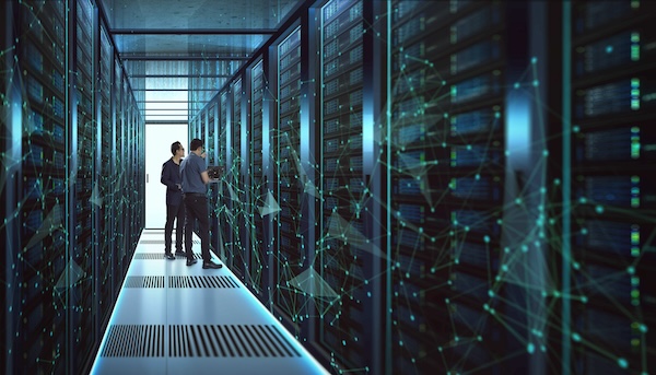 Two men looking at storage servers in a blue tinted room